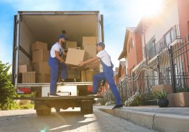 Workers,Unloading,Boxes,From,Van,Outdoors.,Moving,Service